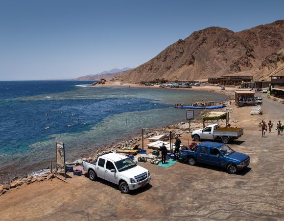 Join Sofy Tours for a day filled with excitement! Our representative will pick you up from your hotel in Dahab or Sharm El-Sheikh, kickstarting a journey of adventure. Our skilled drivers will guide you in air-conditioned jeeps into the heart of the desert, where you'll encounter the Bedouins and their villages. Immerse yourself in their world and savor a moment of serenity with a cup of tea. Next stop: Dahab. Explore the enchanting Wadi Qunai, an oasis adorned with palm trees and a charming sandstone canyon. Experience a unique mode of transportation as you hop on a camel for an authentic ride through the Bedouin villages. The camels will lead the way to the famous Blue Hole for a snorkeling session, rounding off an action-packed day. Afterwards, head to Dahab for a delicious lunch at a local restaurant, soaking in the vibrant atmosphere. Your adventure concludes as you're driven back to your hotel in the comfort of our jeeps. With Sofy Tours, every moment is meticulously crafted for a memorable 9-hour journey into the heart of desert culture and natural wonders.