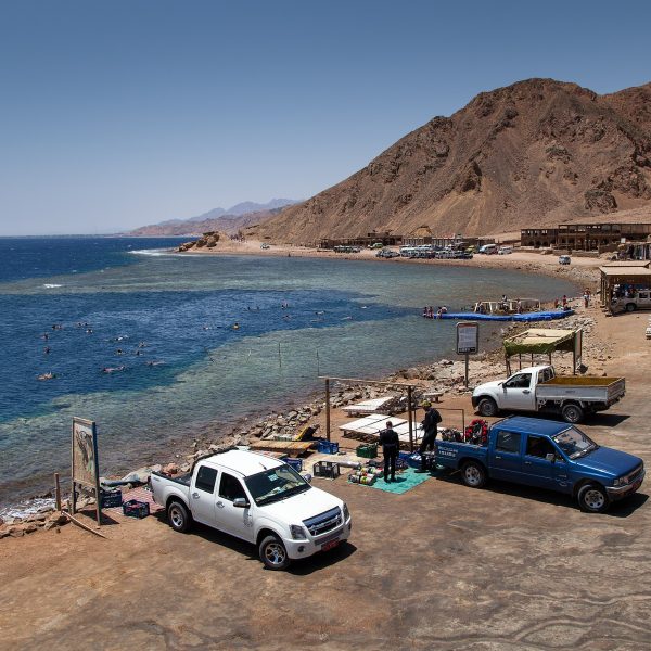 Join Sofy Tours for a day filled with excitement! Our representative will pick you up from your hotel in Dahab or Sharm El-Sheikh, kickstarting a journey of adventure. Our skilled drivers will guide you in air-conditioned jeeps into the heart of the desert, where you'll encounter the Bedouins and their villages. Immerse yourself in their world and savor a moment of serenity with a cup of tea. Next stop: Dahab. Explore the enchanting Wadi Qunai, an oasis adorned with palm trees and a charming sandstone canyon. Experience a unique mode of transportation as you hop on a camel for an authentic ride through the Bedouin villages. The camels will lead the way to the famous Blue Hole for a snorkeling session, rounding off an action-packed day. Afterwards, head to Dahab for a delicious lunch at a local restaurant, soaking in the vibrant atmosphere. Your adventure concludes as you're driven back to your hotel in the comfort of our jeeps. With Sofy Tours, every moment is meticulously crafted for a memorable 9-hour journey into the heart of desert culture and natural wonders.