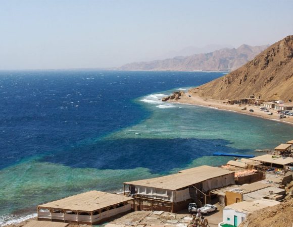 Join Sofy Tours for a day filled with excitement! Our representative will pick you up from your hotel in Dahab or Sharm El-Sheikh, kickstarting a journey of adventure. Our skilled drivers will guide you in air-conditioned jeeps into the heart of the desert, where you'll encounter the Bedouins and their villages. Immerse yourself in their world and savor a moment of serenity with a cup of tea. Next stop: Dahab. Explore the enchanting Wadi Qunai, an oasis adorned with palm trees and a charming sandstone canyon. Experience a unique mode of transportation as you hop on a camel for an authentic ride through the Bedouin villages. The camels will lead the way to the famous Blue Hole for a snorkeling session, rounding off an action-packed day. Afterwards, head to Dahab for a delicious lunch at a local restaurant, soaking in the vibrant atmosphere. Your adventure concludes as you're driven back to your hotel in the comfort of our jeeps. With Sofy Tours, every moment is meticulously crafted for a memorable 9-hour journey into the heart of desert culture and natural wonders.